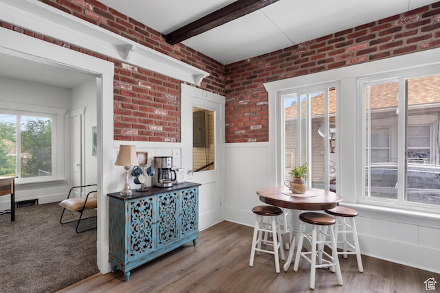 2955 S Jefferson Ave E, Ogden, UT 84403 - dining space with wood finished floors, wainscoting, beam ceiling, and brick wall