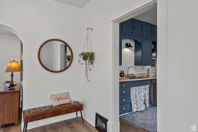 2955 S Jefferson Ave E, Ogden, UT 84403 - hallway featuring a sink, wood finished floors, arched walkways, and baseboards