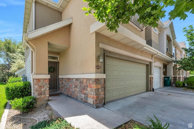 14069 S Rutherford Ave W, Bluffdale, UT 84065 - view of front of home with stucco siding, stone siding, and a garage