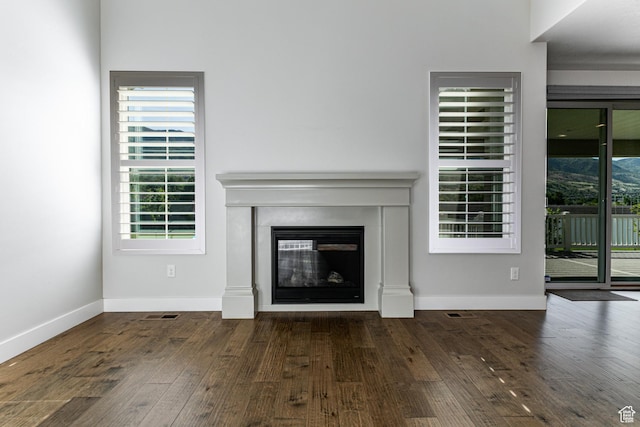 1065 S 425 W, Farmington, UT 84025 - unfurnished living room featuring hardwood / wood-style flooring, a glass covered fireplace, and baseboards