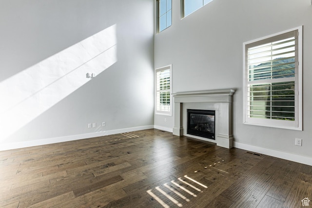 1065 S 425 W, Farmington, UT 84025 - unfurnished living room featuring a glass covered fireplace, hardwood / wood-style flooring, and baseboards