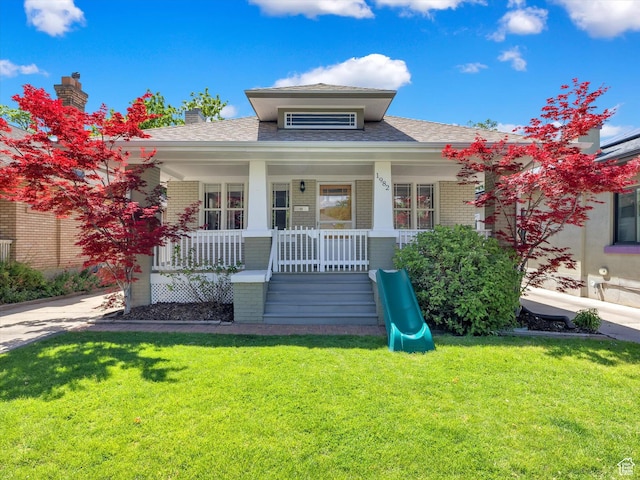 1982 S 800 E, Salt Lake City, UT 84105 - bungalow with brick siding, a front lawn, a shingled roof, and covered porch