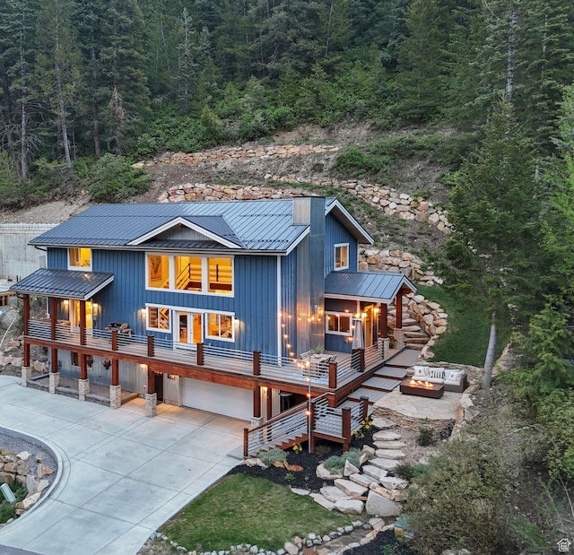 705 Parkview Dr, Summit Park, UT 84098 - back of property featuring metal roof, a standing seam roof, an outdoor fire pit, board and batten siding, and a garage