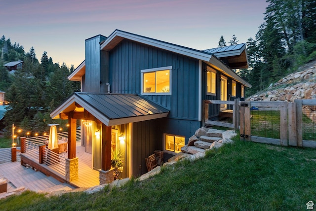 705 Parkview Dr, Summit Park, UT 84098 - view of front of house featuring a standing seam roof, a deck, a lawn, and metal roof