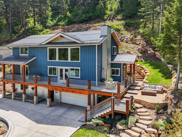 705 Parkview Dr, Summit Park, UT 84098 - view of front of house featuring driveway, a fire pit, metal roof, and an attached garage