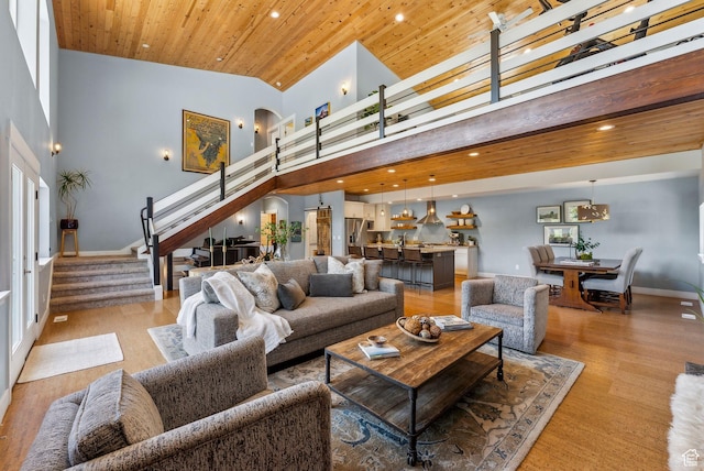 705 Parkview Dr, Summit Park, UT 84098 - living room featuring stairway, light wood-style floors, a towering ceiling, recessed lighting, and wooden ceiling