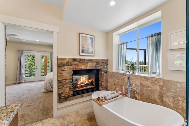 705 Parkview Dr, Summit Park, UT 84098 - full bathroom with a stone fireplace, a soaking tub, recessed lighting, and french doors