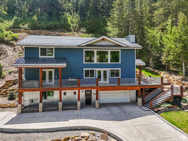 705 Parkview Dr, Summit Park, UT 84098 - view of front of home featuring french doors, metal roof, a garage, and a wooded view