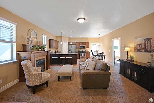 658 S 150 E, Smithfield, UT 84335 - living room with a glass covered fireplace, light colored carpet, baseboards, and a chandelier