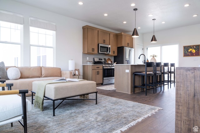 7017 W S Jordan Pkwy, South Jordan, UT 84009 - living room with plenty of natural light, recessed lighting, and dark wood-style flooring