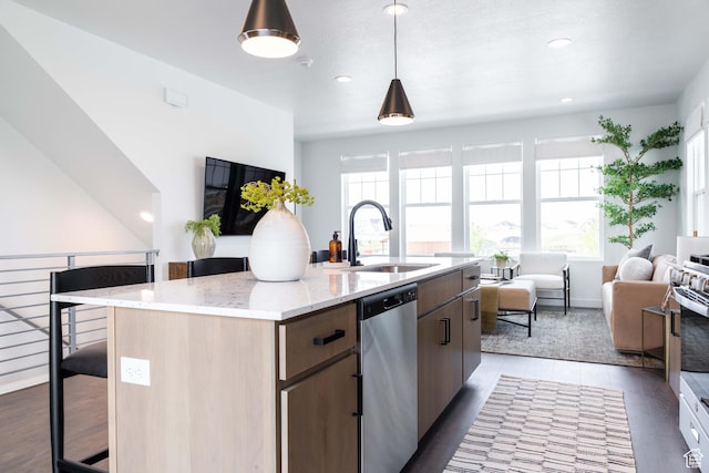 7017 W S Jordan Pkwy, South Jordan, UT 84009 - kitchen featuring stainless steel appliances, a sink, open floor plan, a kitchen island with sink, and a kitchen breakfast bar