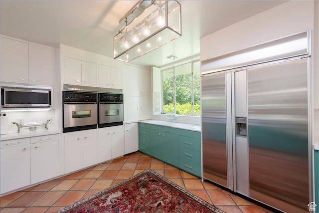 2285 E Cottonwood Cir, Holladay, UT 84117 - kitchen with built in refrigerator, stainless steel microwave, light tile patterned floors, and white cabinets