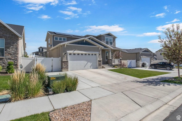 1295 E Granite Peak Rd, Eagle Mountain, UT 84005 - craftsman-style home with stone siding, a gate, concrete driveway, a garage, and stucco siding