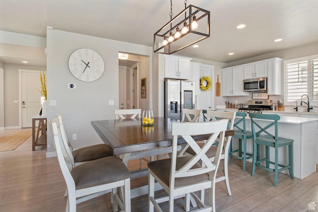 1295 E Granite Peak Rd, Eagle Mountain, UT 84005 - dining area with light wood-style flooring, recessed lighting, and baseboards
