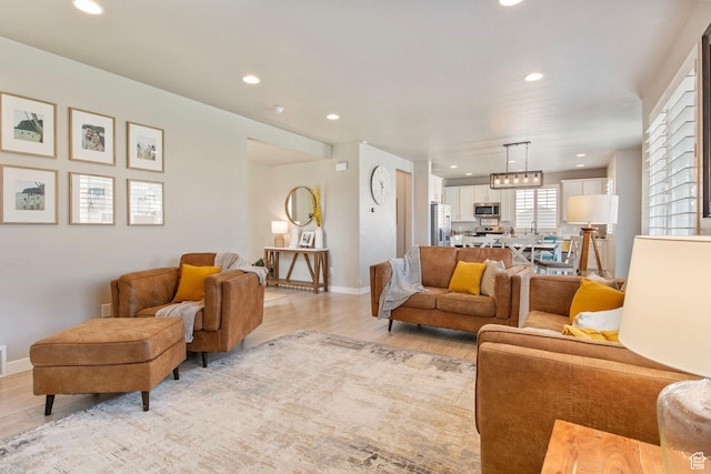 1295 E Granite Peak Rd, Eagle Mountain, UT 84005 - living room with light wood-style floors, recessed lighting, baseboards, and a chandelier