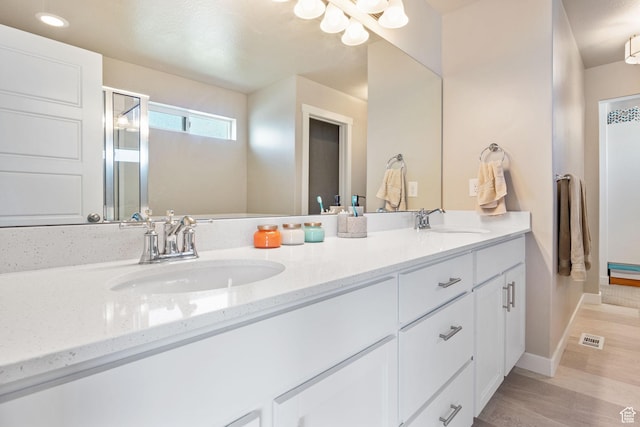 1295 E Granite Peak Rd, Eagle Mountain, UT 84005 - full bathroom with double vanity, wood finished floors, baseboards, a shower stall, and recessed lighting