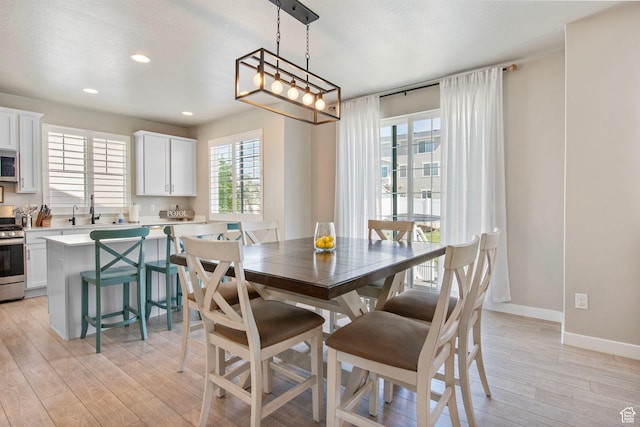 1295 E Granite Peak Rd, Eagle Mountain, UT 84005 - dining room featuring light wood-type flooring, recessed lighting, and baseboards