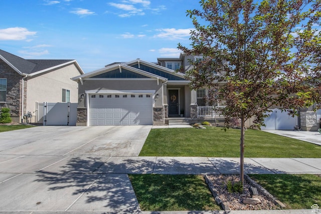 1295 E Granite Peak Rd, Eagle Mountain, UT 84005 - view of front of house with a gate, driveway, a garage, stone siding, and stucco siding
