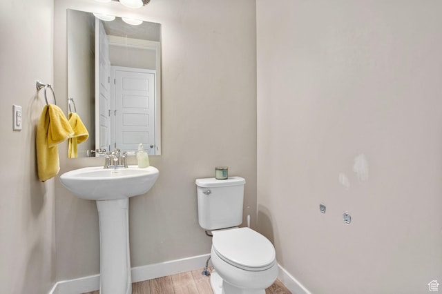 1295 E Granite Peak Rd, Eagle Mountain, UT 84005 - bathroom with toilet, baseboards, and wood finished floors
