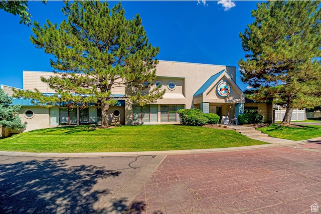 5457 S Break Water Dr W, Taylorsville, UT 84123 - view of front of house featuring stucco siding and a front lawn