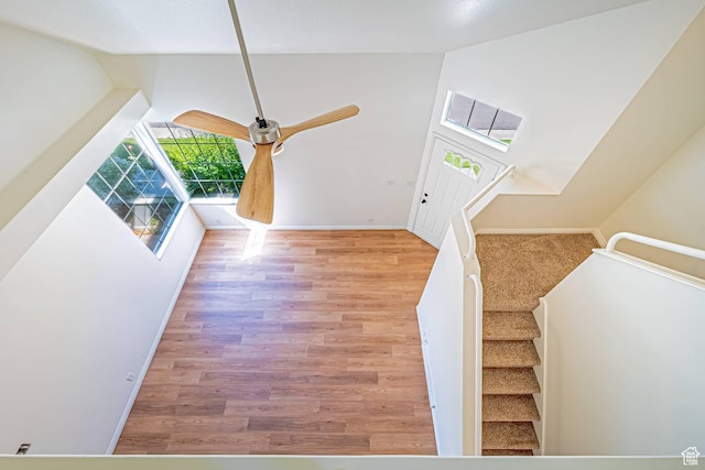 5457 S Break Water Dr W, Taylorsville, UT 84123 - stairs featuring wood finished floors, baseboards, and high vaulted ceiling
