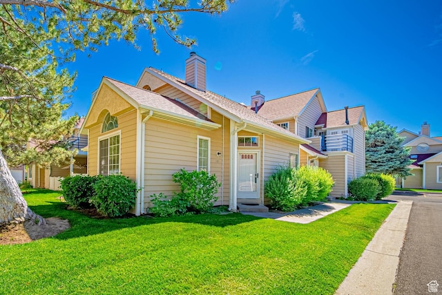 5457 S Break Water Dr W, Taylorsville, UT 84123 - view of front of property with a front yard and a chimney