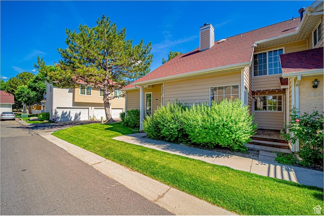 5457 S Break Water Dr W, Taylorsville, UT 84123 - view of front of property with a chimney, a front yard, and roof with shingles