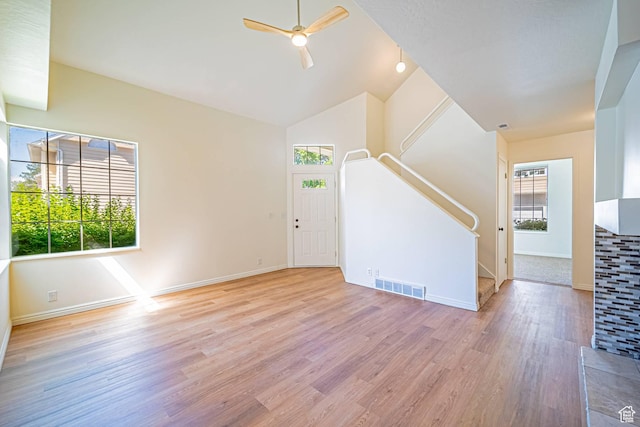 5457 S Break Water Dr W, Taylorsville, UT 84123 - empty room with ceiling fan, stairs, baseboards, wood finished floors, and high vaulted ceiling