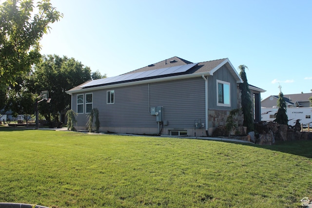 730 S 300 W, Garland, UT 84312 - view of side of home with a yard, roof mounted solar panels, and board and batten siding