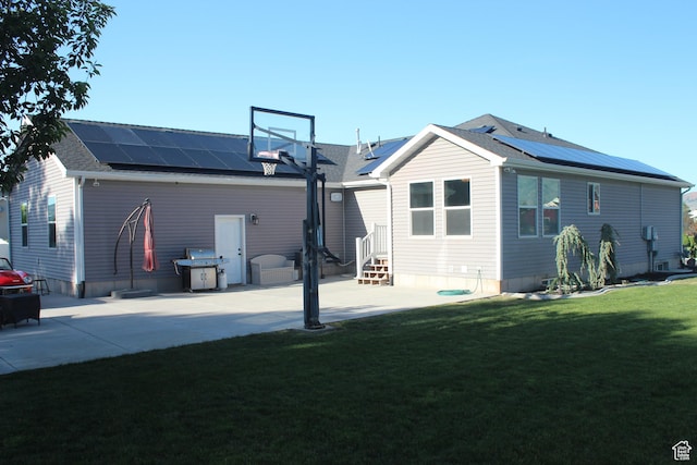 730 S 300 W, Garland, UT 84312 - rear view of property featuring roof mounted solar panels, a lawn, entry steps, and a shingled roof