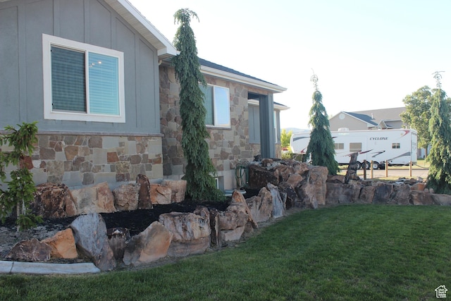 730 S 300 W, Garland, UT 84312 - view of property exterior featuring stone siding, a yard, and board and batten siding