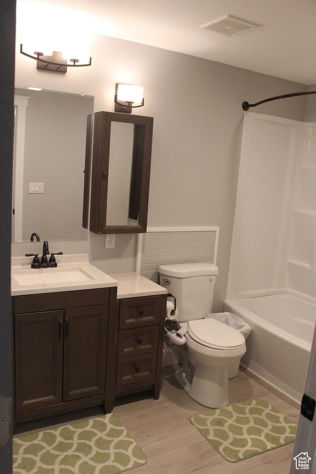 730 S 300 W, Garland, UT 84312 - full bath with vanity, toilet, wood finished floors, and washtub / shower combination