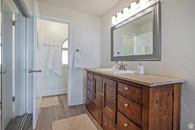 96 S 350 E, North Salt Lake, UT 84054 - bathroom featuring wood finished floors, vanity, and baseboards