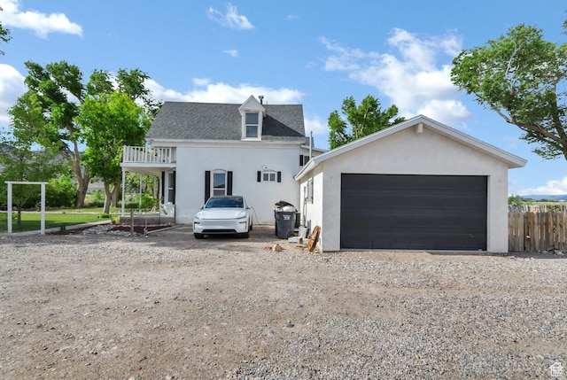 1031 S Brooklyn Rd, Elsinore, UT 84724 - view of front facade featuring stucco siding, a balcony, and a detached garage