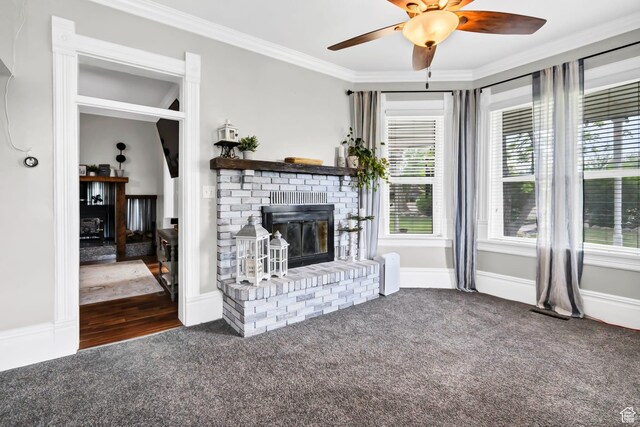 1031 S Brooklyn Rd, Elsinore, UT 84724 - unfurnished living room with a brick fireplace, carpet, ornamental molding, a ceiling fan, and baseboards