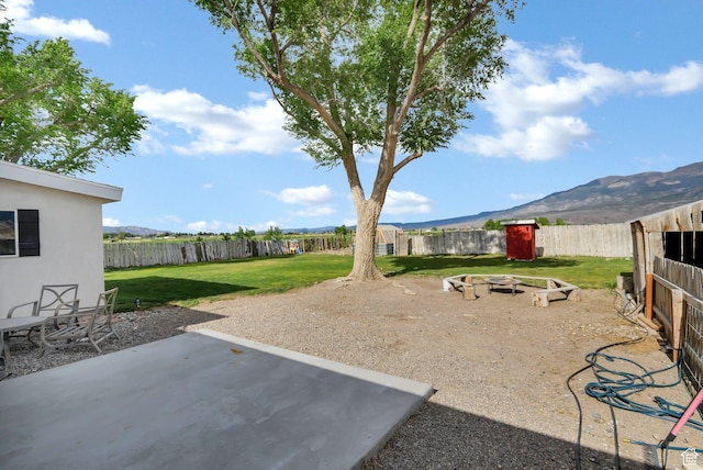 1031 S Brooklyn Rd, Elsinore, UT 84724 - view of yard featuring an outdoor fire pit, a mountain view, and a patio area