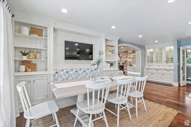 3 Dawn Hill Dr, Sandy, UT 84092 - dining area featuring a fireplace, dark wood-type flooring, ornamental molding, recessed lighting, and arched walkways