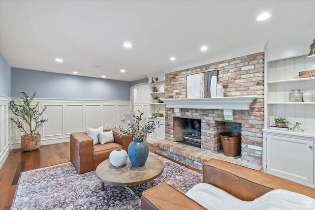 3 Dawn Hill Dr, Sandy, UT 84092 - living area with wood finished floors, built in shelves, wainscoting, a decorative wall, and a fireplace