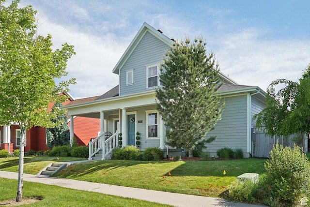 4411 W S Jordan Pkwy, South Jordan, UT 84009 - view of front of home with covered porch, a front yard, and a shingled roof