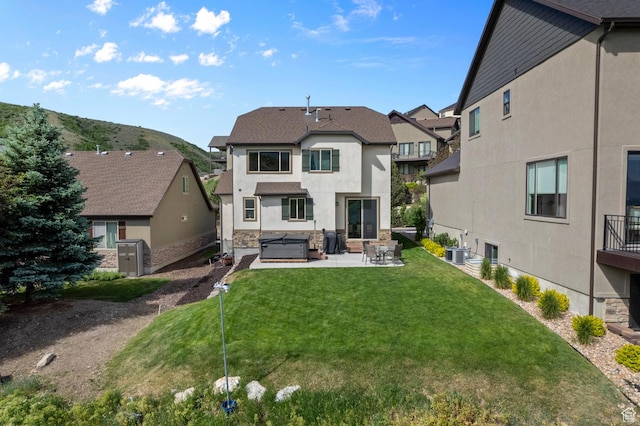 14585 S Delacroix Dr S, Draper, UT 84020 - rear view of house featuring a patio, a hot tub, a residential view, stucco siding, and a yard