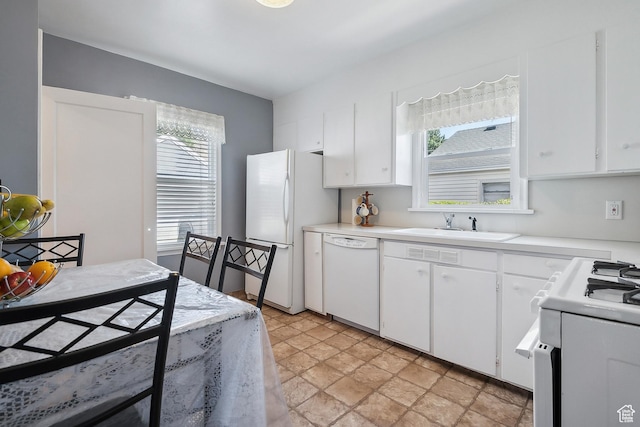 2058 Van Buren Ave, Ogden, UT 84401 - kitchen featuring white appliances, a sink, light countertops, and white cabinetry