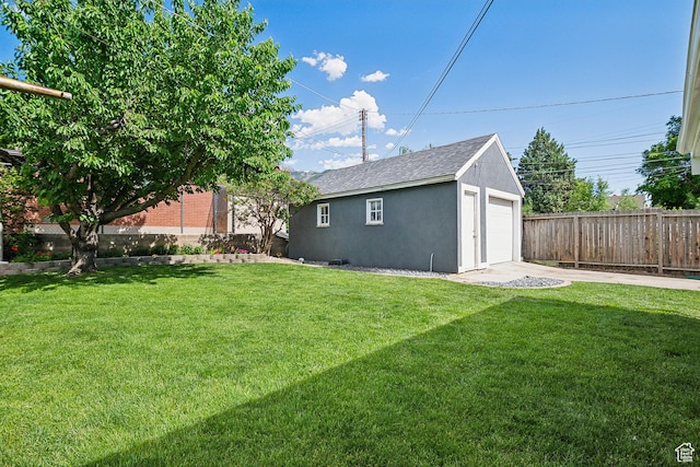 2058 Van Buren Ave, Ogden, UT 84401 - view of yard with a garage, an outdoor structure, and driveway