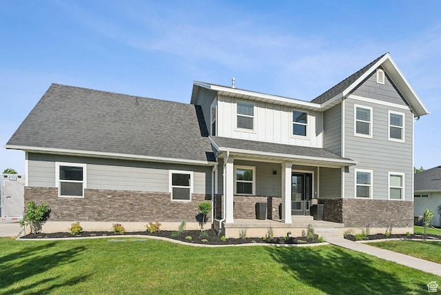 1184 S 2300 E, Spanish Fork, UT 84660 - craftsman inspired home featuring stone siding, covered porch, a front yard, and board and batten siding