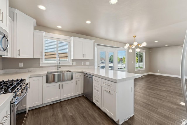 1184 S 2300 E, Spanish Fork, UT 84660 - kitchen featuring stainless steel appliances, a sink, a peninsula, dark wood-style floors, and recessed lighting