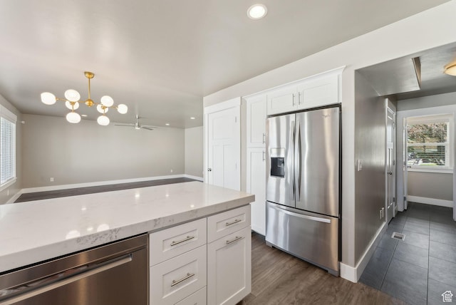 1184 S 2300 E, Spanish Fork, UT 84660 - kitchen with appliances with stainless steel finishes, light stone countertops, white cabinets, baseboards, and a chandelier