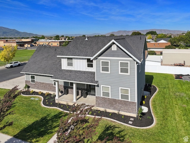 1184 S 2300 E, Spanish Fork, UT 84660 - view of front facade with stone siding, a mountain view, a patio, and roof with shingles