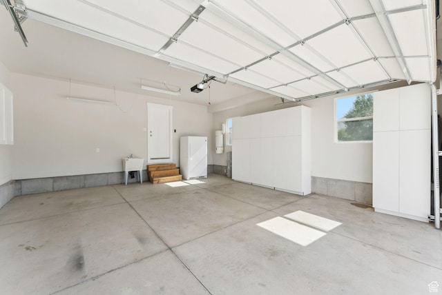 1184 S 2300 E, Spanish Fork, UT 84660 - garage featuring freestanding refrigerator, a garage door opener, and a sink