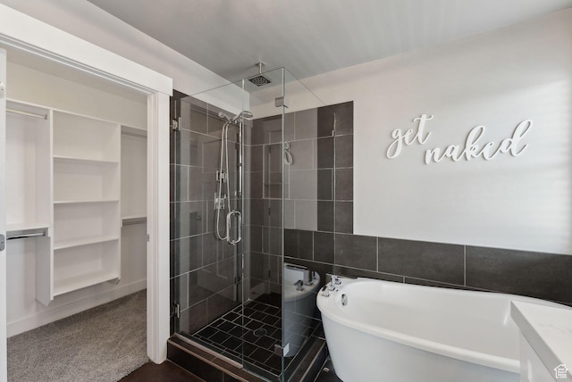 1184 S 2300 E, Spanish Fork, UT 84660 - full bathroom with a stall shower, a walk in closet, a freestanding tub, and tile walls