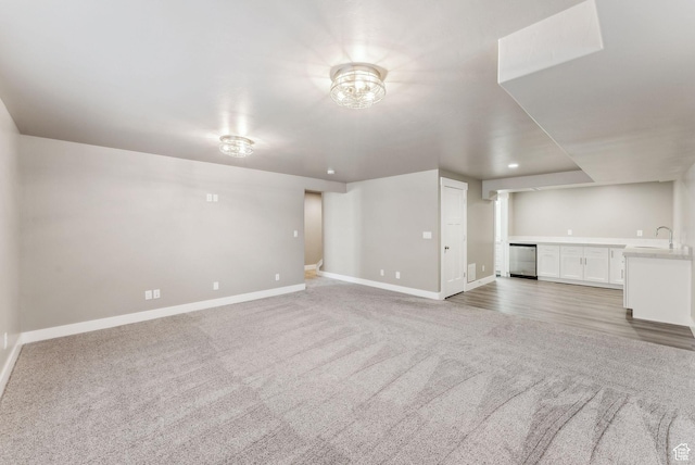 1184 S 2300 E, Spanish Fork, UT 84660 - unfurnished living room featuring baseboards, light colored carpet, and a sink