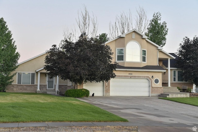 14114 S 3600 W, Bluffdale, UT 84065 - view of front of property featuring a garage, stucco siding, driveway, and a front yard